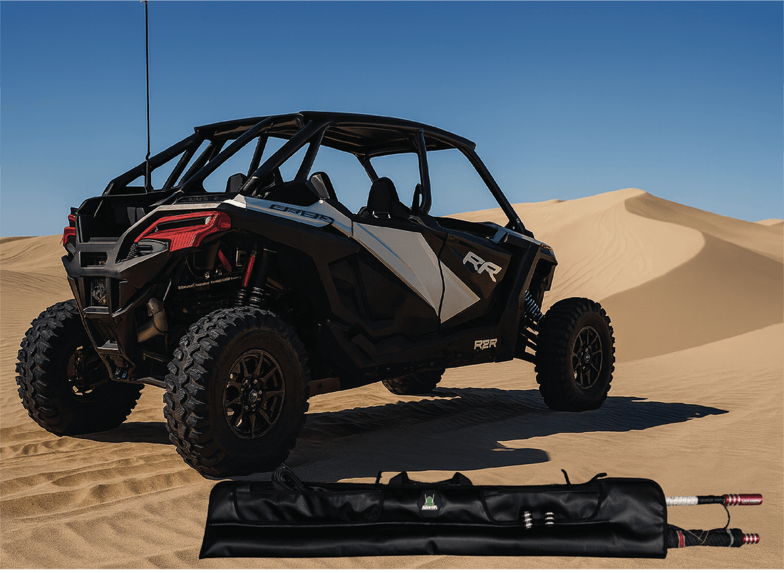 Off-road vehicle on sand dunes with a folded canopy in the foreground