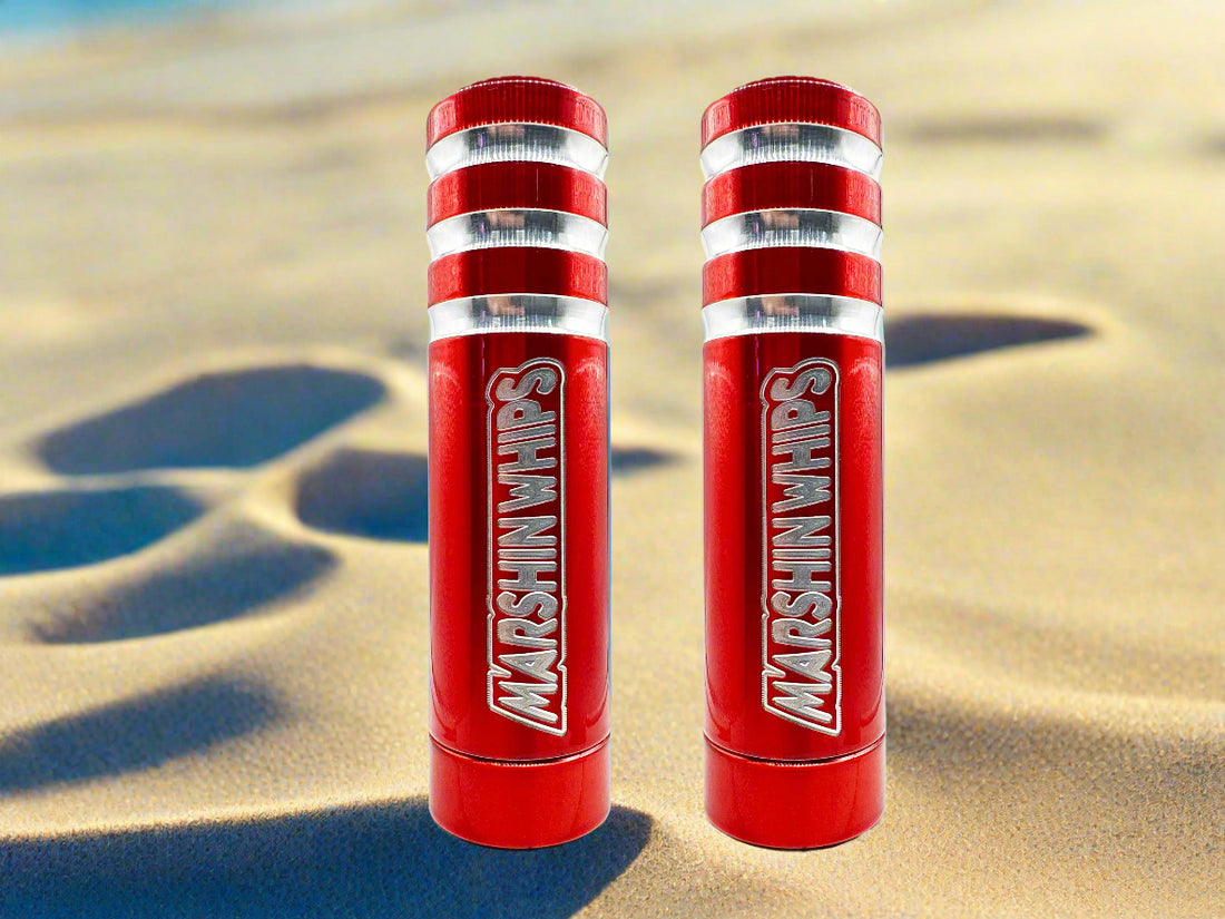 Two red bases with white stripes and Marshin whips branding on a beach