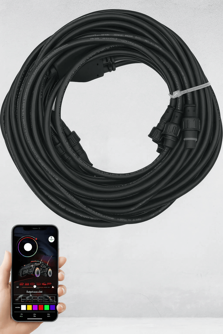 Coiled black cable for rock lights with smartphone displaying the PRO RGB App used.