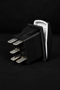 A single black UTV electrical rocker switch with four metal terminal posts and a white recessed back, photographed on a black background.