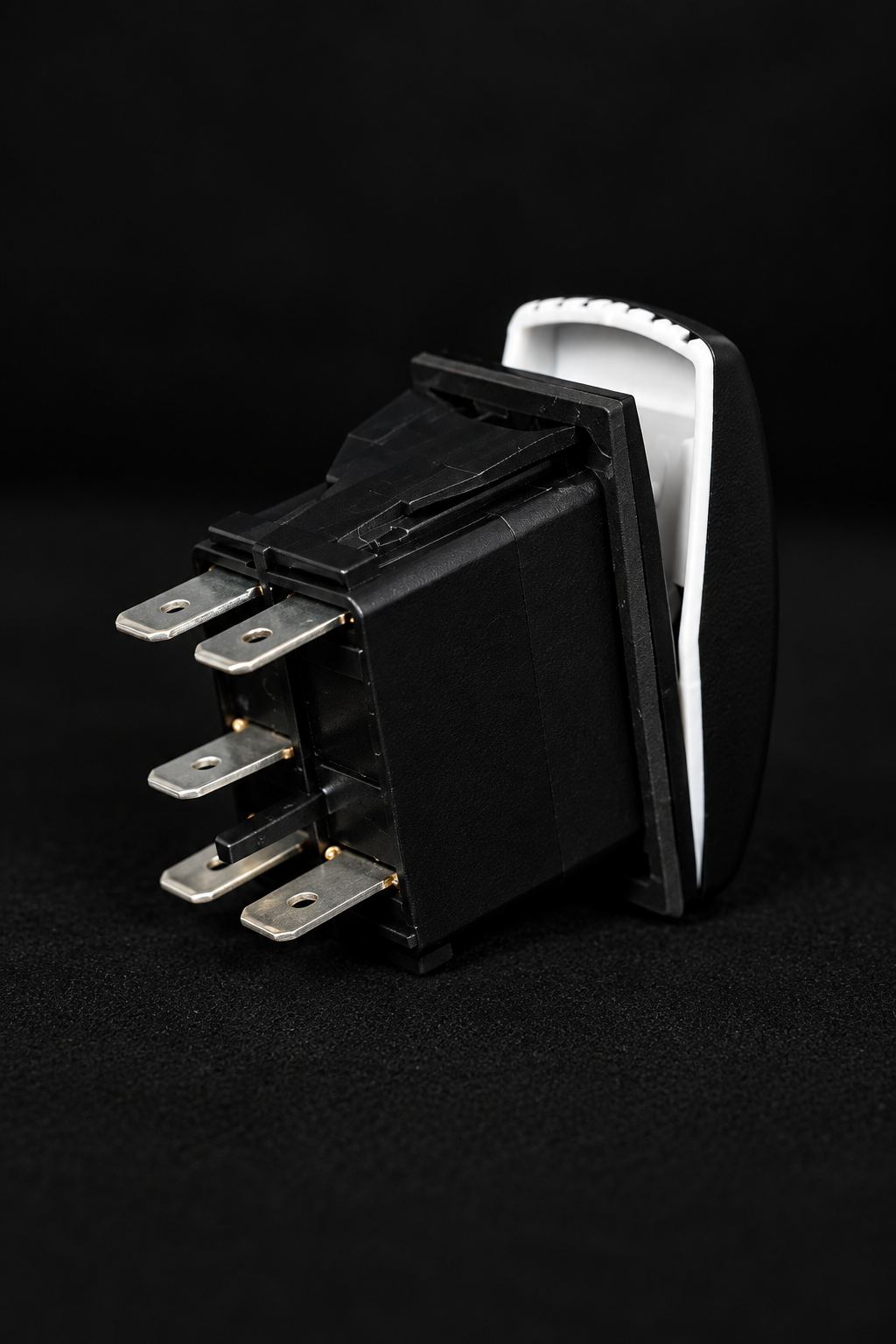 A single black UTV electrical rocker switch with four metal terminal posts and a white recessed back, photographed on a black background.