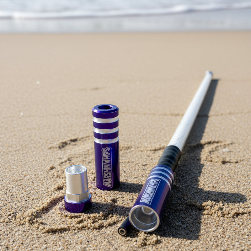 Purple Game Changer Whip on a sandy beach with ocean waves in the background