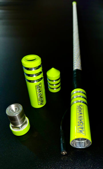 A set of green Game Changer Whips with metallic accents, displayed on a dark background, highlighting their design and construction.