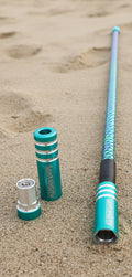 Teal game changer lighted whip on a sandy surface