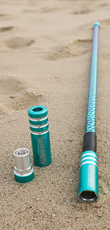 Teal game changer lighted whip on a sandy surface