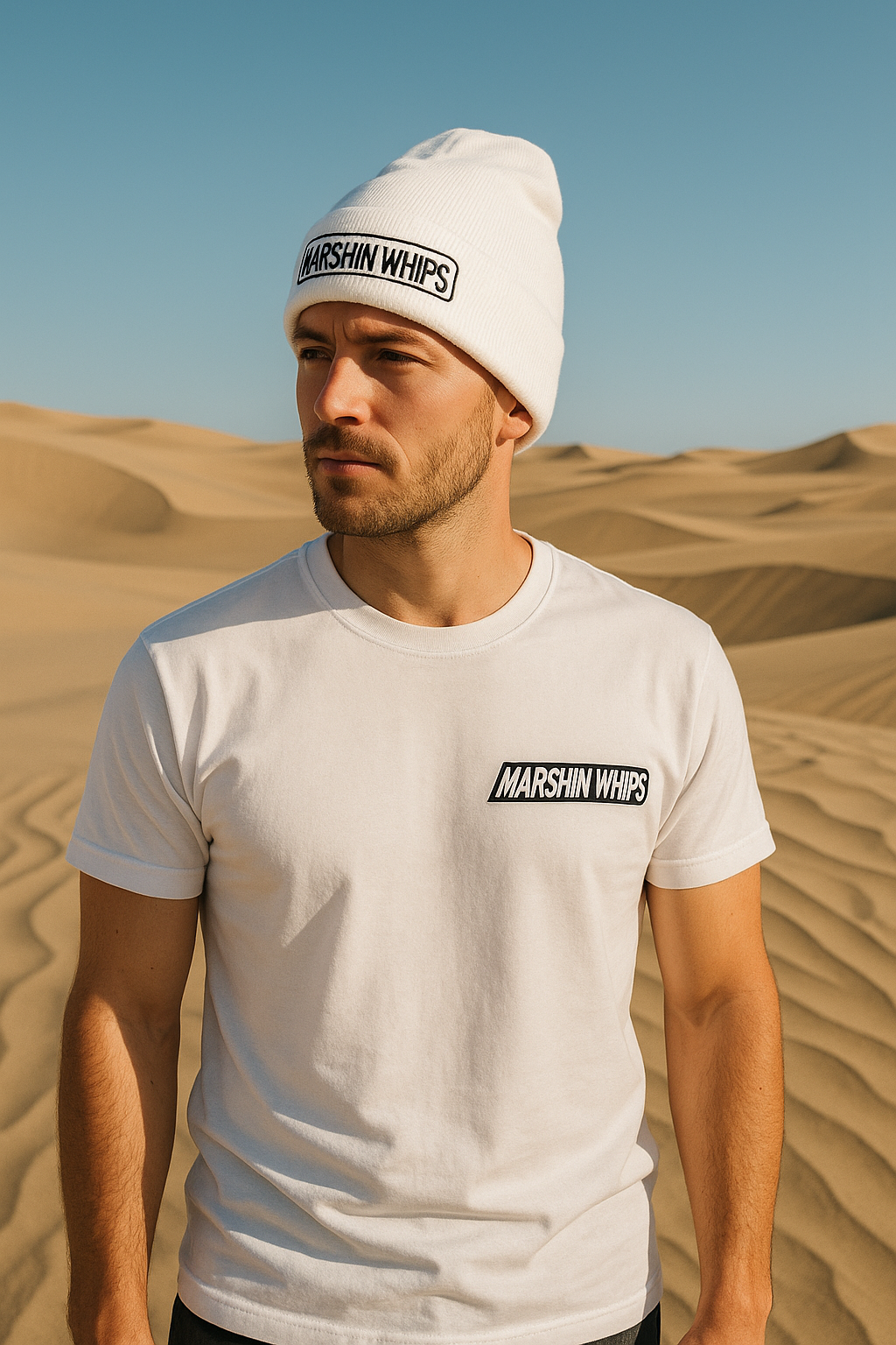 Man wearing a white t-shirt and beanie with 'Marshin Whips' logo in a desert setting