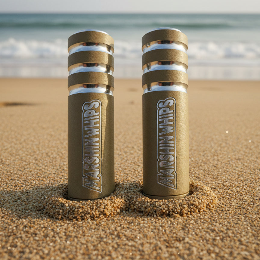 Two Marshin Whips on a sandy beach with ocean waves in the background